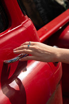 ‘Two of a kind’ double finger ring with a round Ostro Blue Topaz set in sterling silver being worn by model