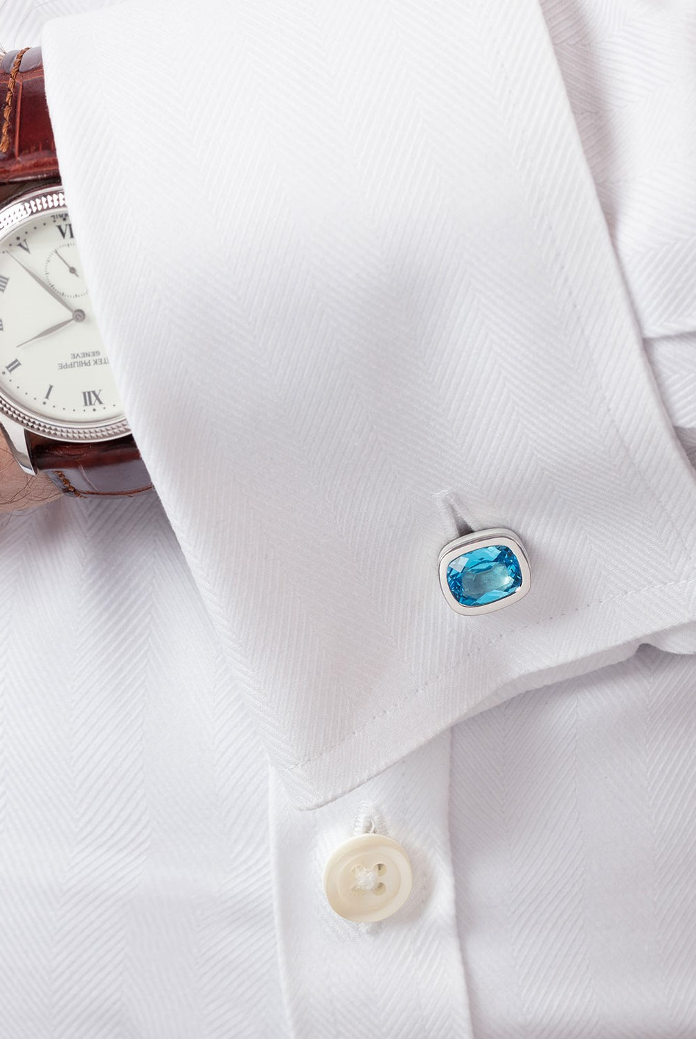 ‘Off the Cuff’ cushion cufflinks with a pair of cushion Ostro Blue Topaz set in sterling silver being worn by model
