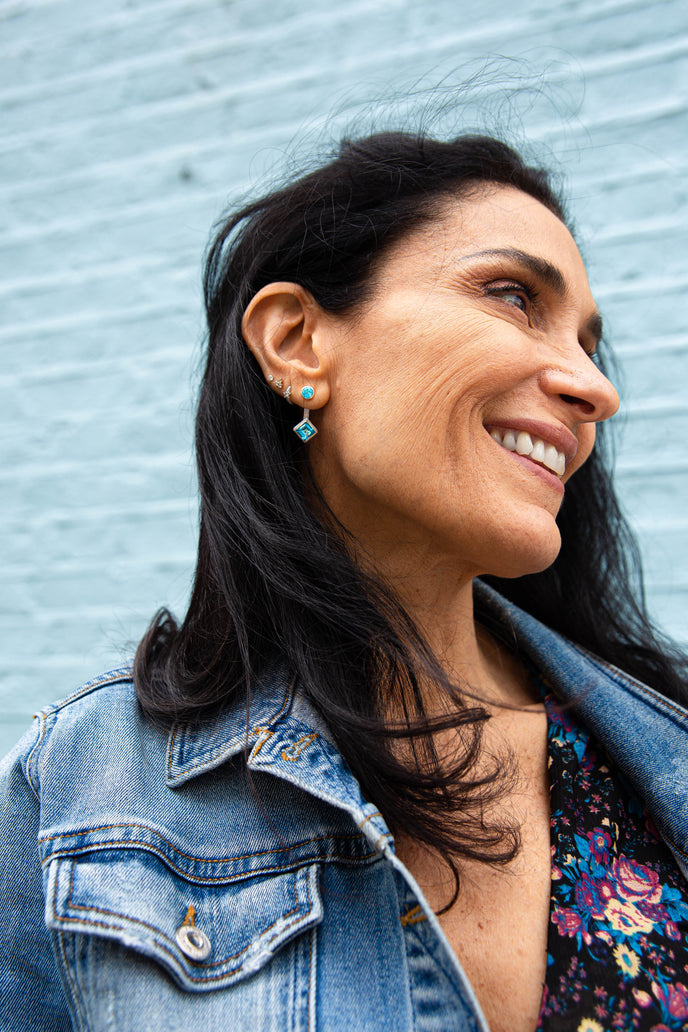 ‘Mix and Match’ earring drops with a pair of square Ostro Blue Topaz set in sterling silver paired with our ‘Play by ear’ stud earrings with a pair of round Ostro Blue topaz set in Sterling Silver being worn by model