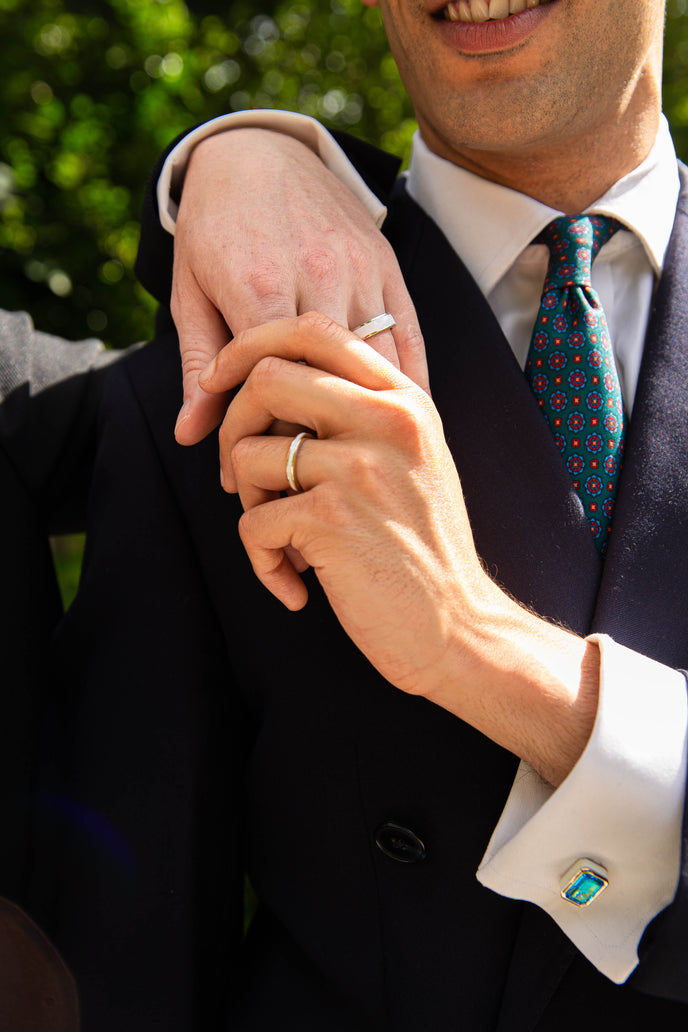 A modern couple wearing their ‘Hidden Gem’ Sterling Silver rings for him and her as well as our ‘off the Cuff’ octagon cufflinks with a pair of Octagon Ostro Blue Topaz set in sterling silver