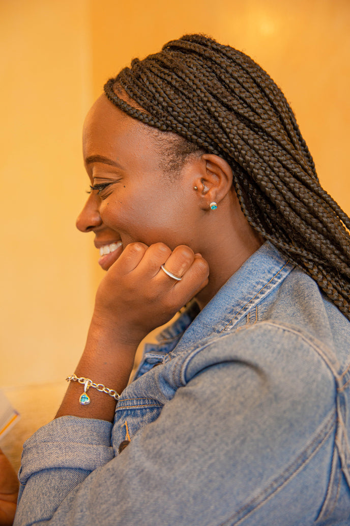  Our ‘Tradition with a twist’ charm with a heart Ostro Blue Topaz set in Sterling Silver being worn on a silver bracelet along with our 'Hidden Gem' for her with a Ostro Blue Topaz surprise set in Sterling Silver