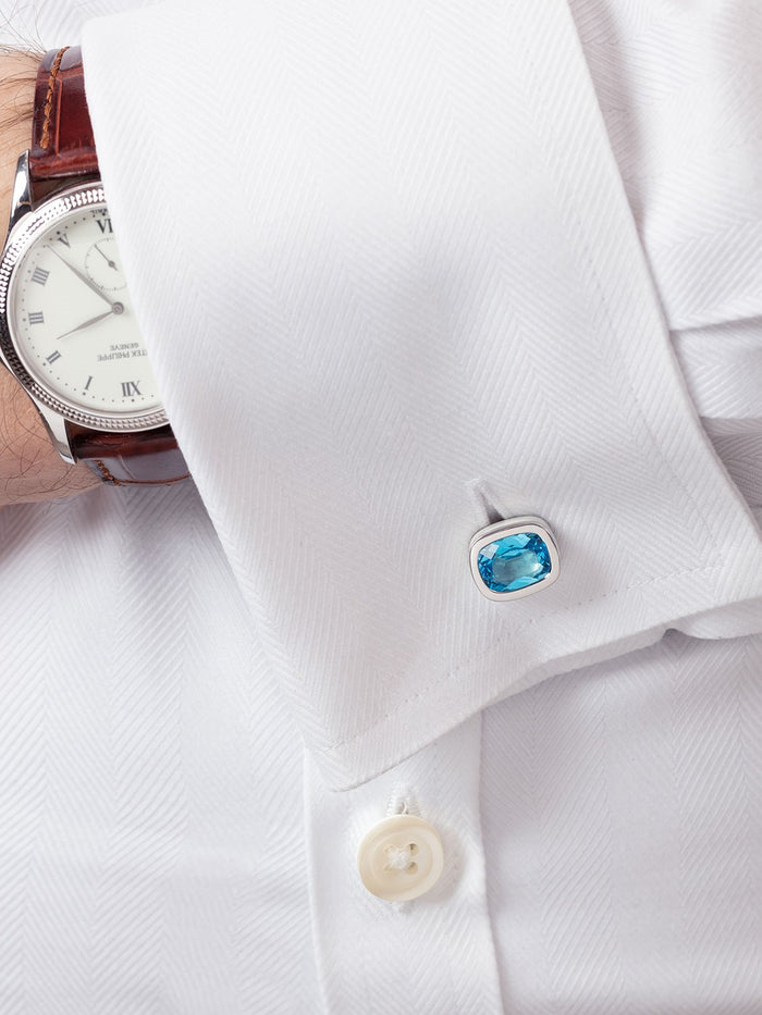 ‘Off the Cuff’ cushion cufflinks with a pair of cushion Ostro Blue Topaz set in sterling silver being worn by model