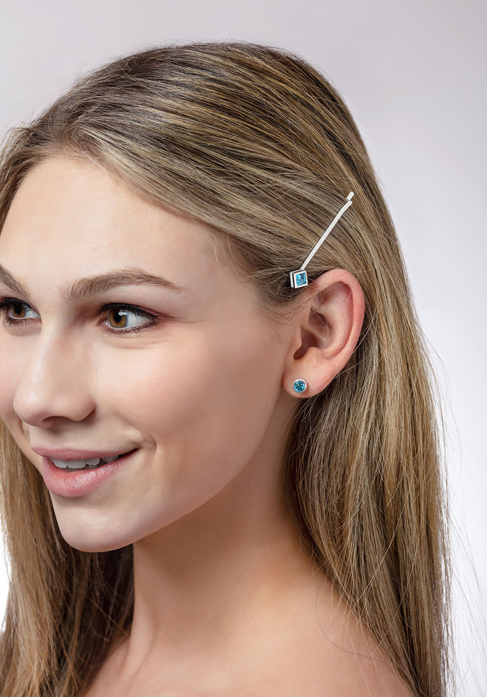 ‘Play by ear’ stud earrings with a pair of round Ostro Blue topaz set in Sterling Silver wearing and our ‘Hairloom’ hair slider with a square Ostro Blue Topaz set in Sterling Silver being worn by model