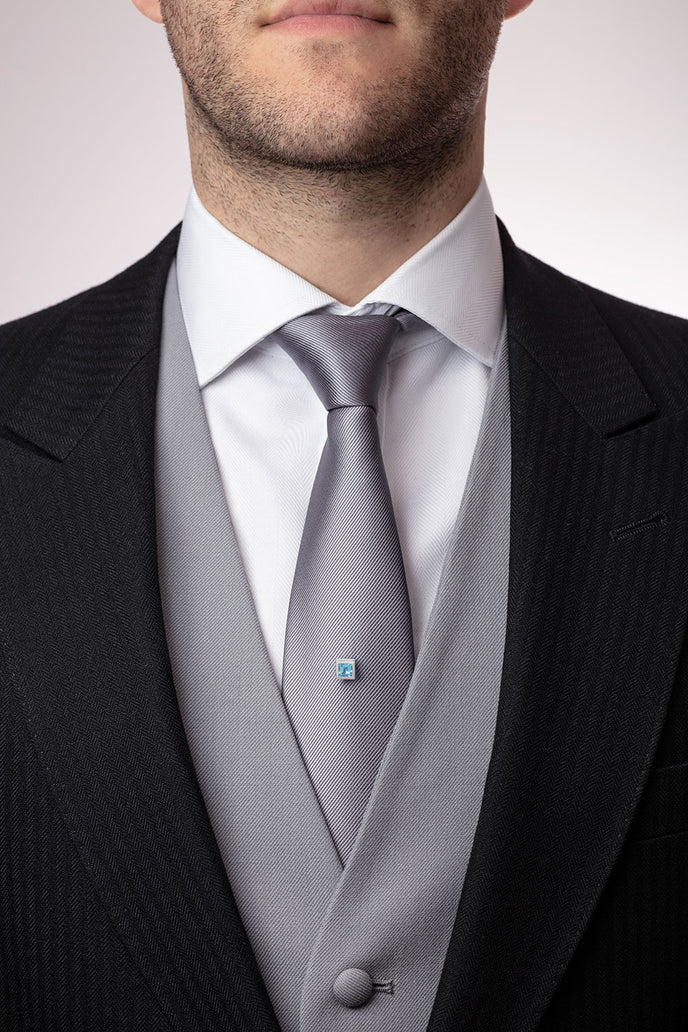 ‘Tie the knot’ tie pin with a square Ostro Blue Topaz set in sterling silver being worn by model